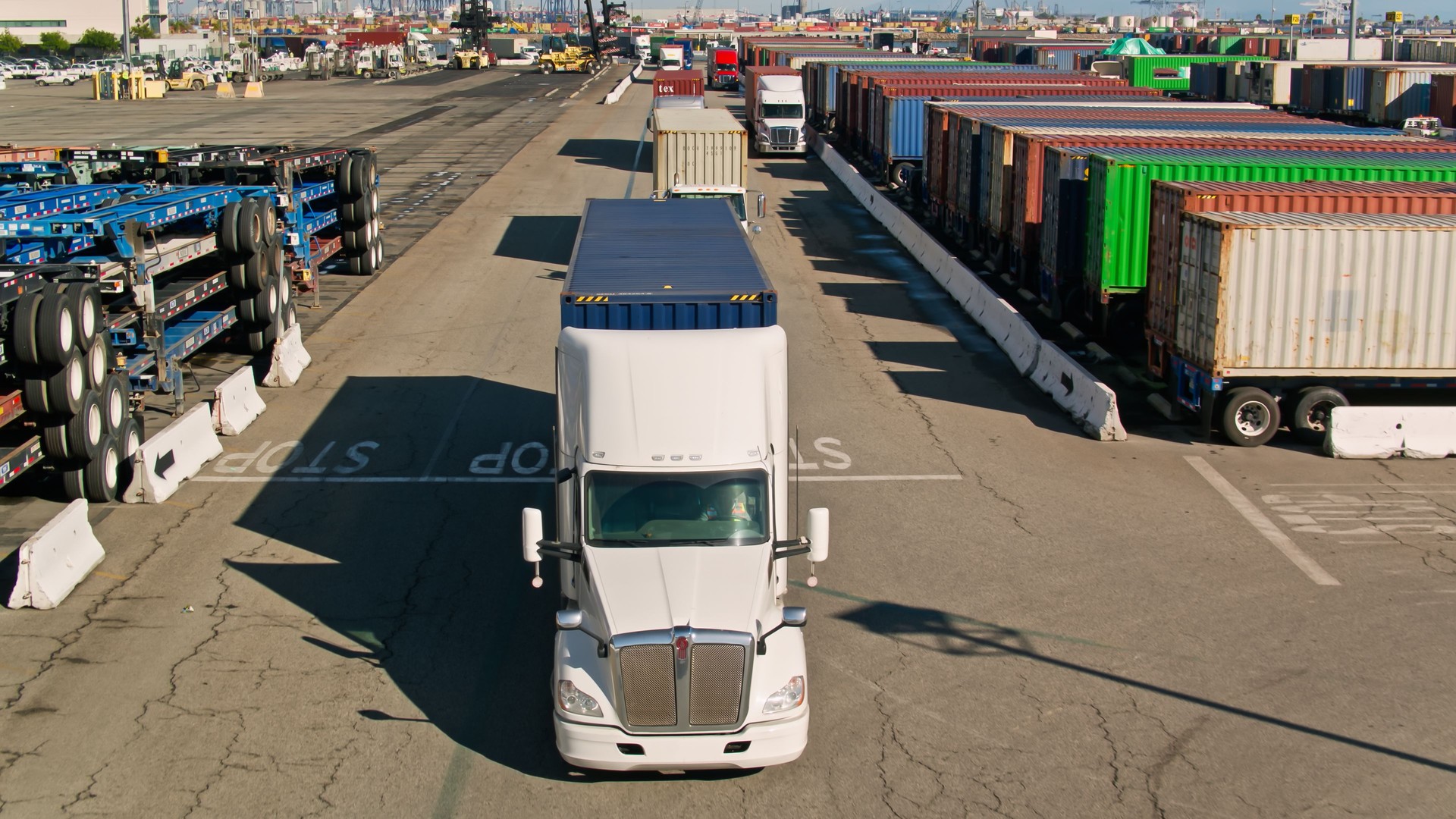 Drone Shot of a Truck Driving Through Container Terminal in Port of LA