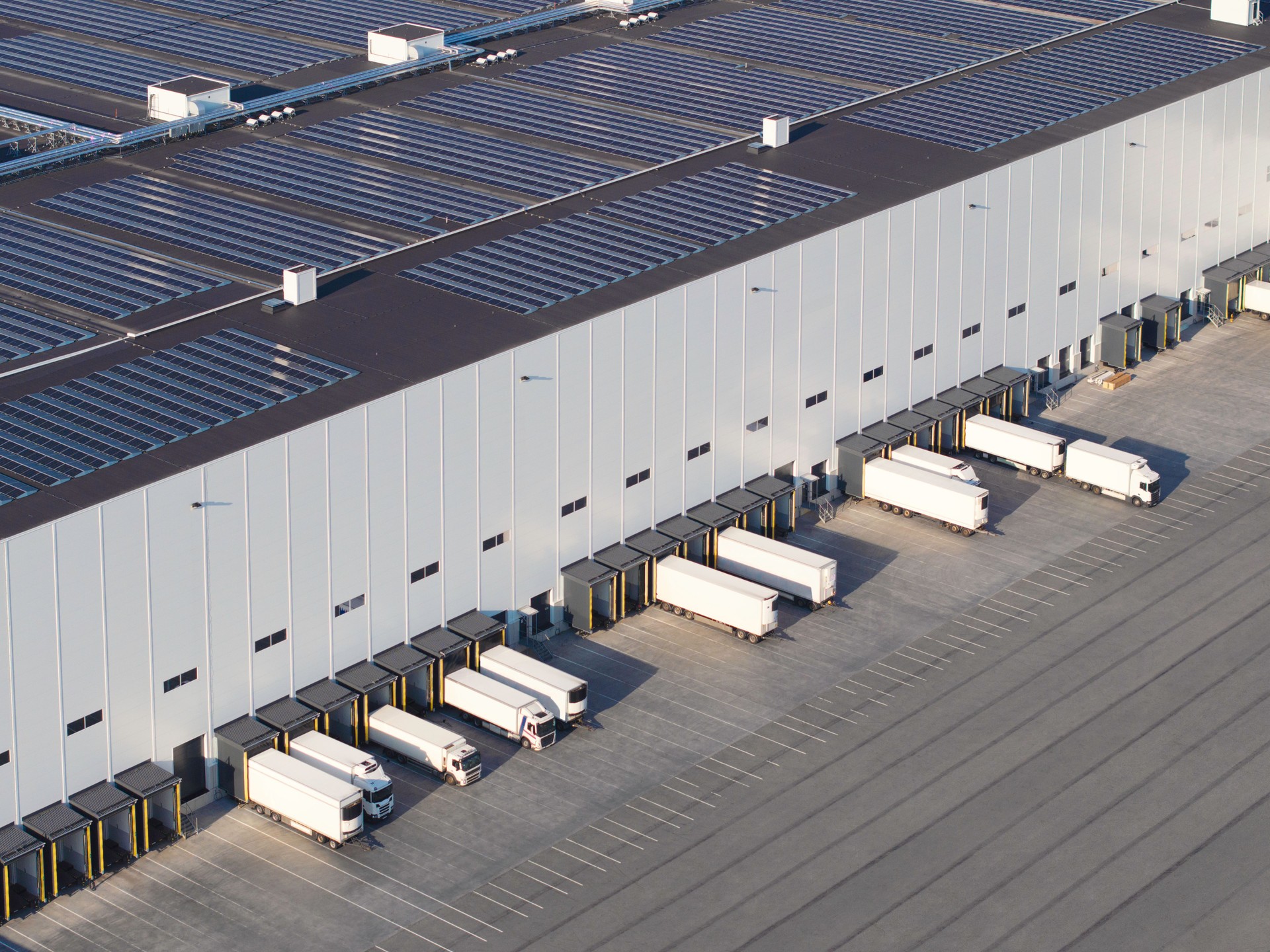 Loading docks at a large distribution warehouse with solar power on the roof